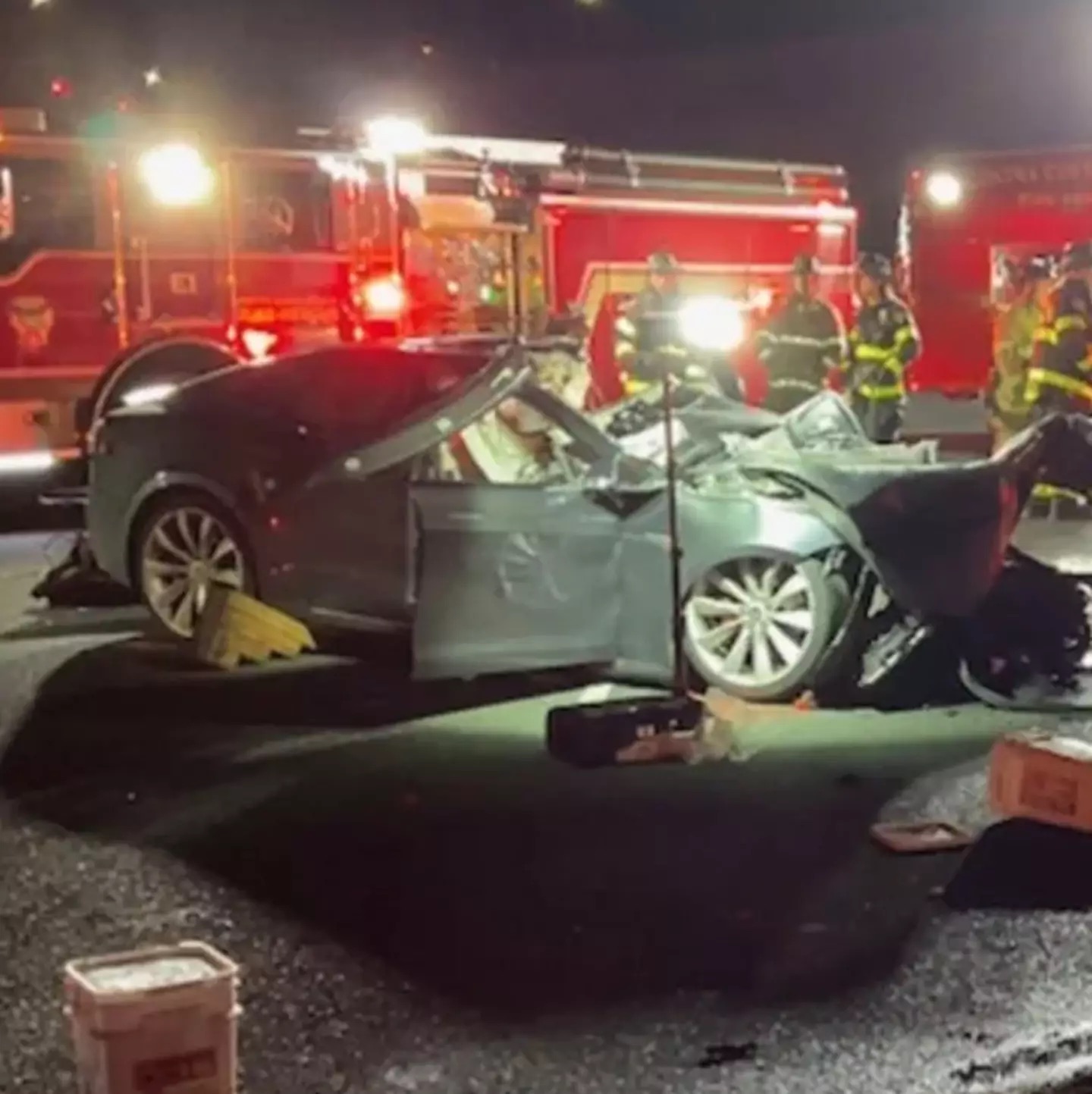 The aftermath of a Tesla crash involving autopilot mode, where a firetruck was struck, leading to the tragic death of 31-year-old Genesis Mendoza