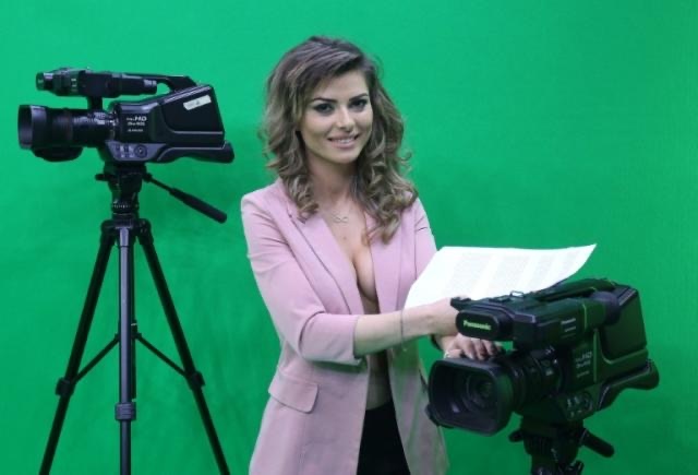 Behind-the-scenes image of the bold Albanian news presenter preparing for her controversial broadcast