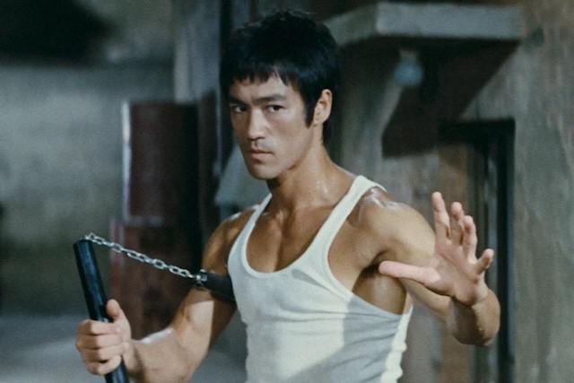 Bruce Lee in action, demonstrating his incredible skill and iconic style in Enter the Dragon, a role that solidified his place in cinematic history