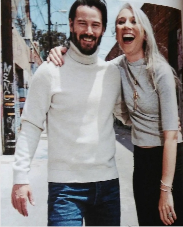 Keanu Reeves and Alexandra Grant share a joyful and relaxed moment while smiling for the camera during a casual outing