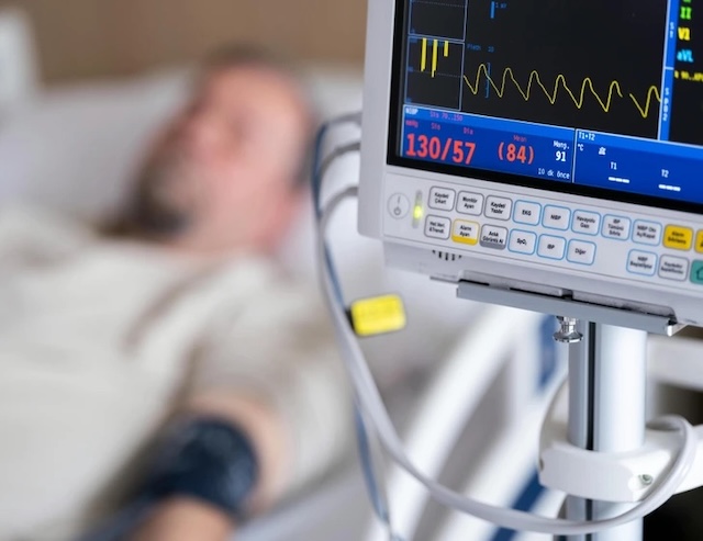 A hospital monitor displaying critical signs, signaling a medical emergency as the result of a heart attack diagnosis