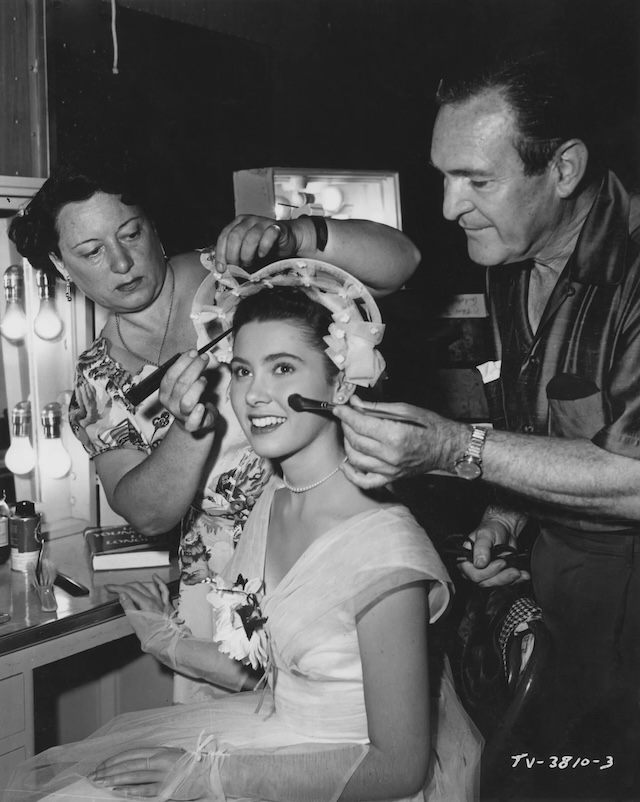 Elinor Donahue being prepped for a scene on set, a glimpse behind the scenes as her glamorous look was carefully crafted for the camera