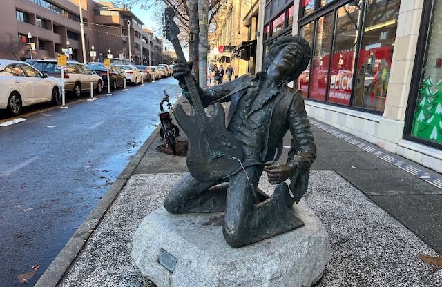 A statue of Jimi Hendrix in Seattle, commemorating his immense contribution to music and culture, capturing the essence of the iconic musician in an unforgettable pose