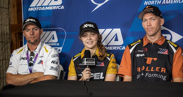 Kayla Yaakov at a press conference, answering questions and showcasing her maturity and talent as a professional motorcycle racer