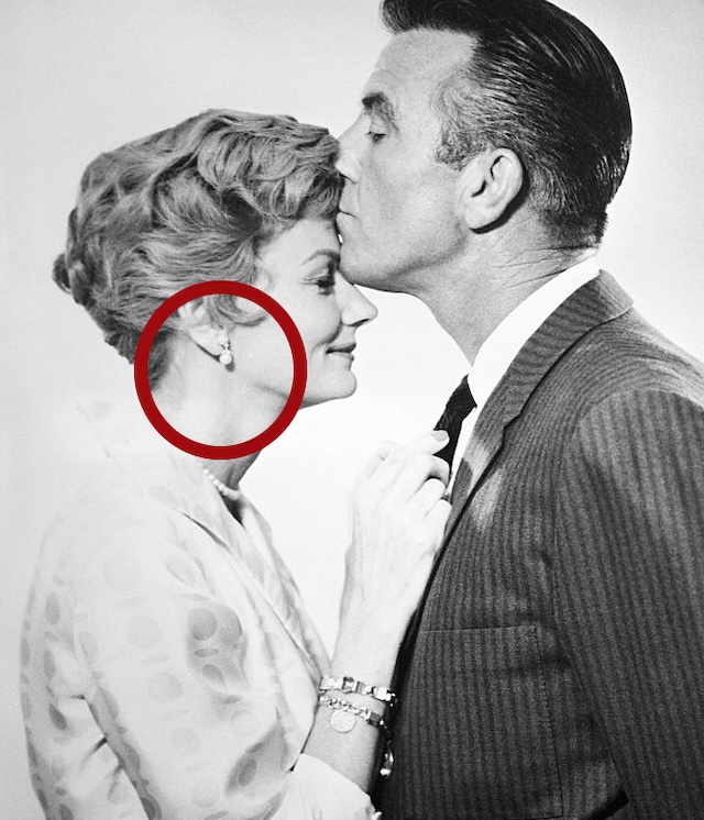 A heartwarming moment from Leave It to Beaver, where June Cleaver, played by Barbara Billingsley, is lovingly kissed on the forehead by her husband, Ward Cleaver, portrayed by Hugh Beaumont