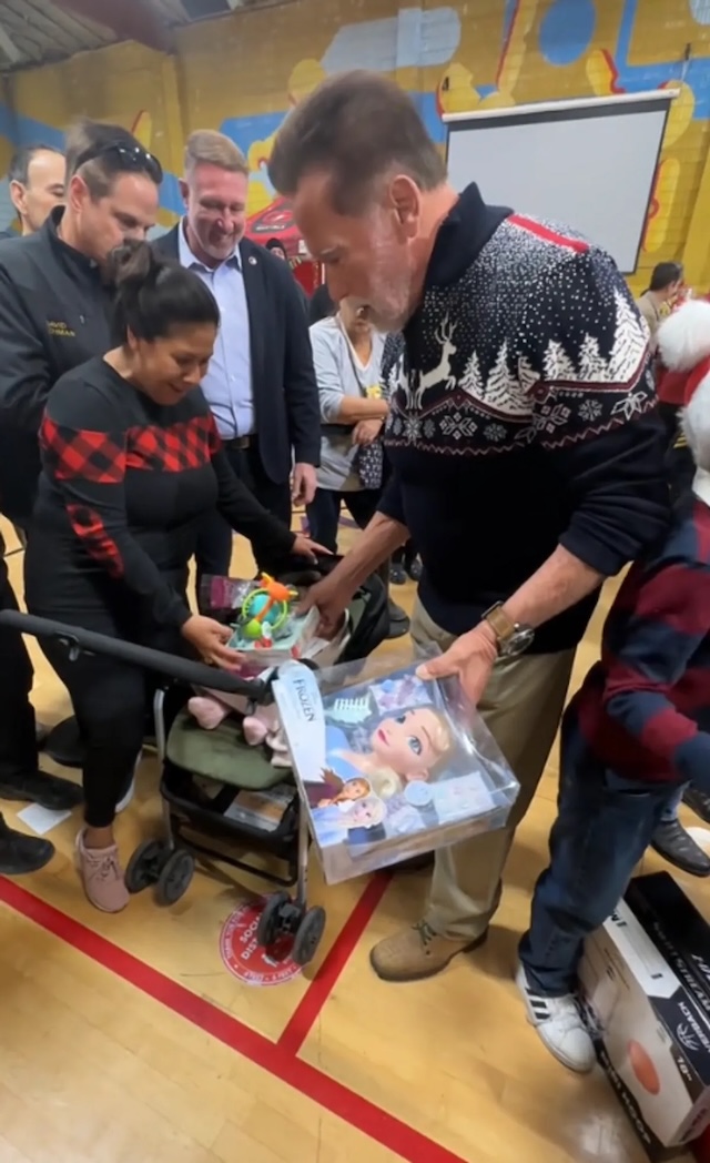 Arnold Schwarzenegger surprises fans with his festive spirit while gifting toys to children in need at a holiday event