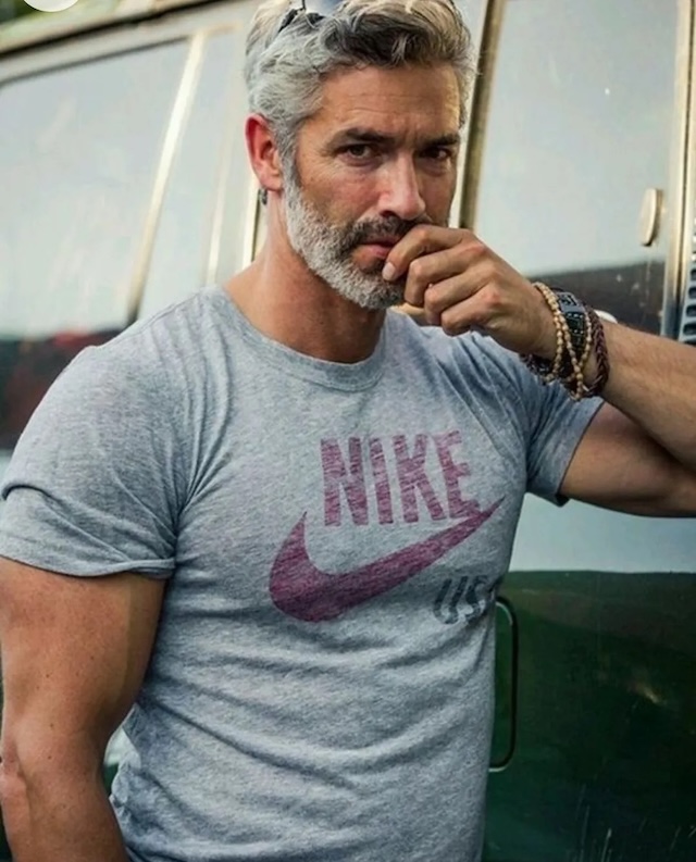  A man with premature gray hair exemplifies strength and style, challenging stereotypes about aging