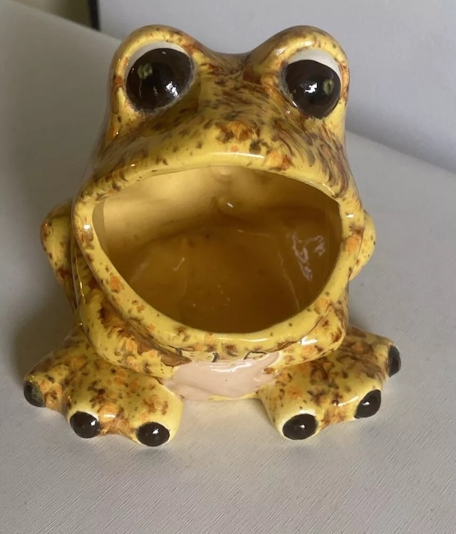 A yellow-speckled ceramic frog sponge holder, blending quirky charm with practical design for a retro kitchen vibe