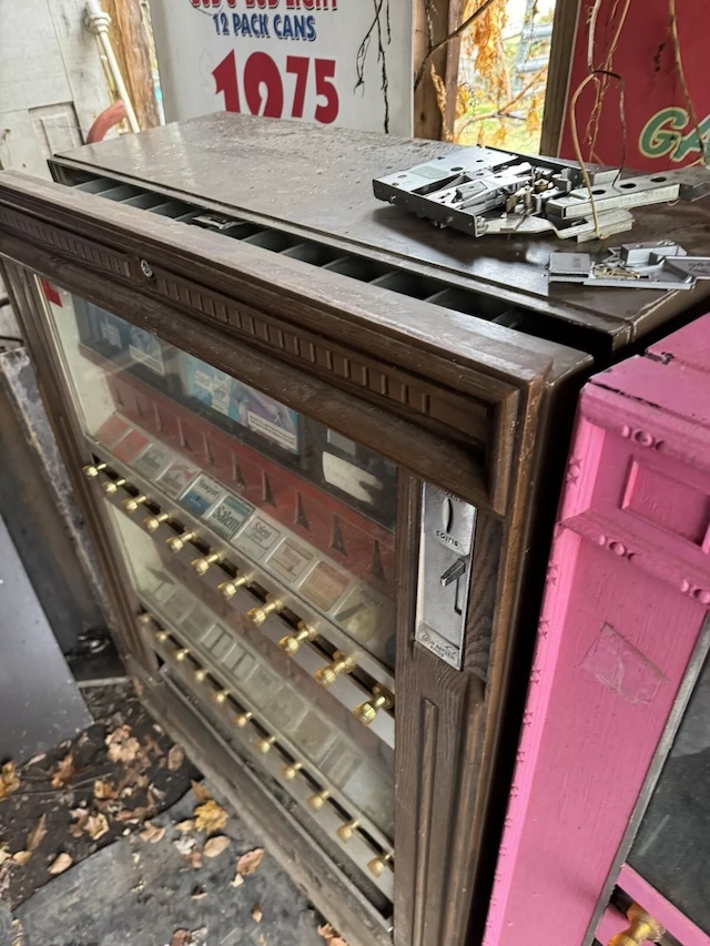 The upper portion of the machine highlights its coin-operated slot and aged signage, revealing decades of history and usage