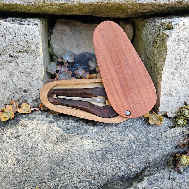 Resting on a stone, this jaw harp case highlights its vintage charm and historical significance