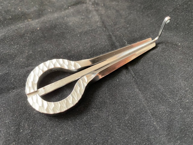 The intricate texture of this metal jaw harp reflects the fine artistry involved in its creation