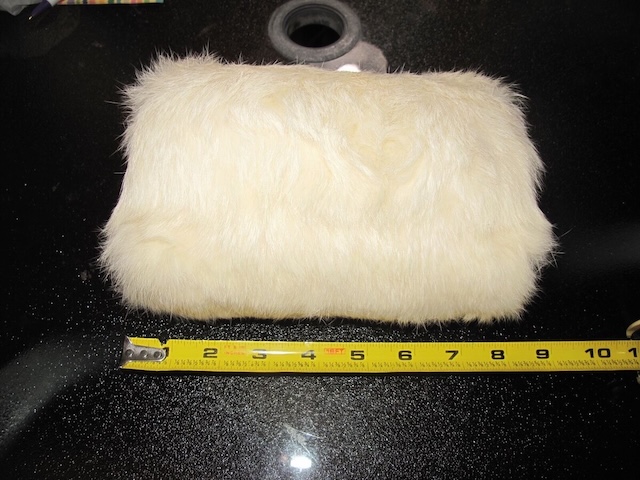 A closer look at a well-preserved vintage fur hand muff, showcasing its plush texture and compact elegance that defined winter fashion