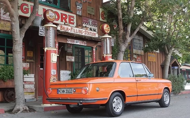 Another stunning orange BMW 2002 Tii captured in its natural habitat, a perfect example of the car’s undeniable charm and iconic status on the road