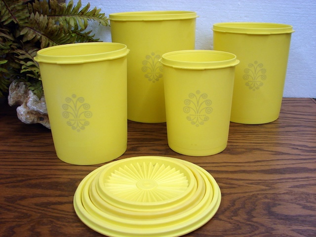 A collection of vintage Tupperware containers stacked together, their lids forming a neat and colorful pattern. These containers were once the staple of every well-organized kitchen