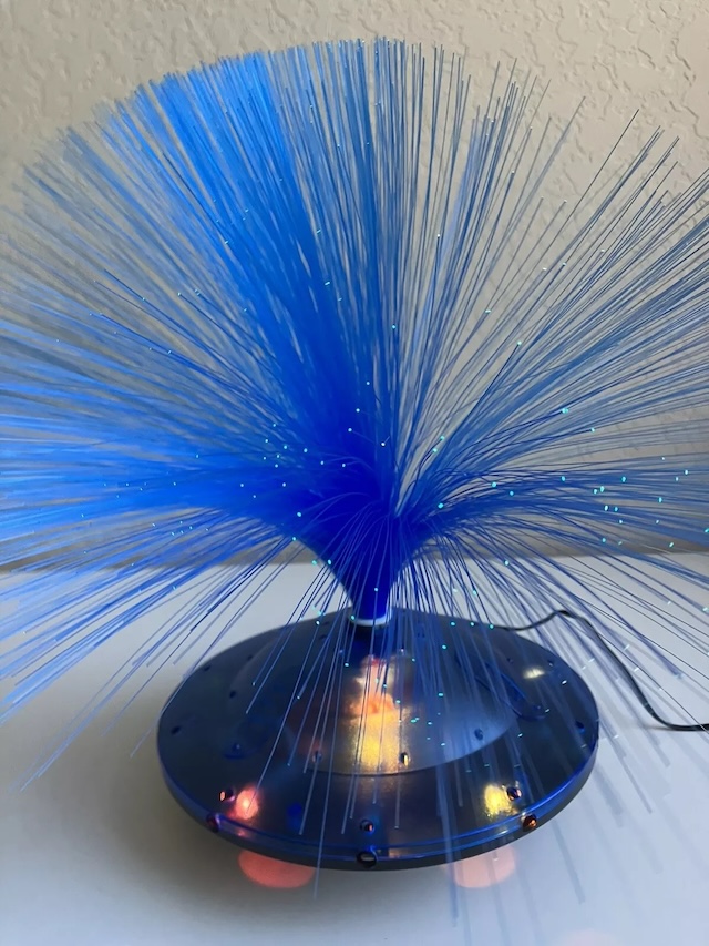 A stunning example of the vintage fiber optic lamp, showcasing vivid blue strands illuminated for an unforgettable retro ambiance