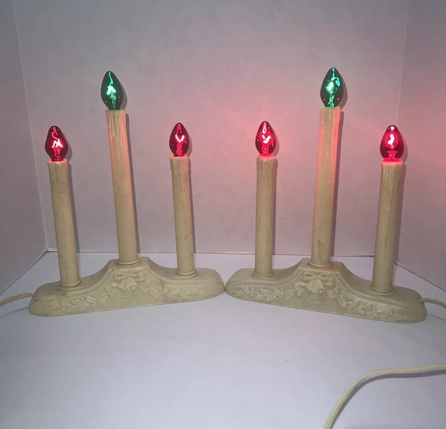 A set of electric candle decorations shining in nostalgic red and green hues, adding a warm festive spirit