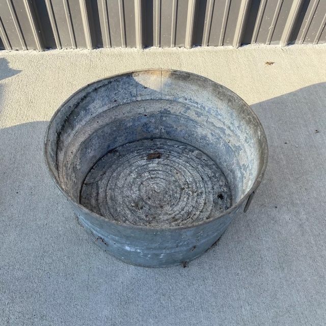 This weathered washtub reveals years of hardworking history, from laundry days to impromptu ice buckets at summer gatherings