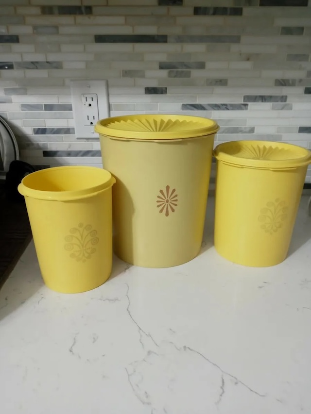 A trio of vintage Tupperware containers with lids that still retain their iconic design. These containers are not only functional but hold sentimental value for many who grew up with them.