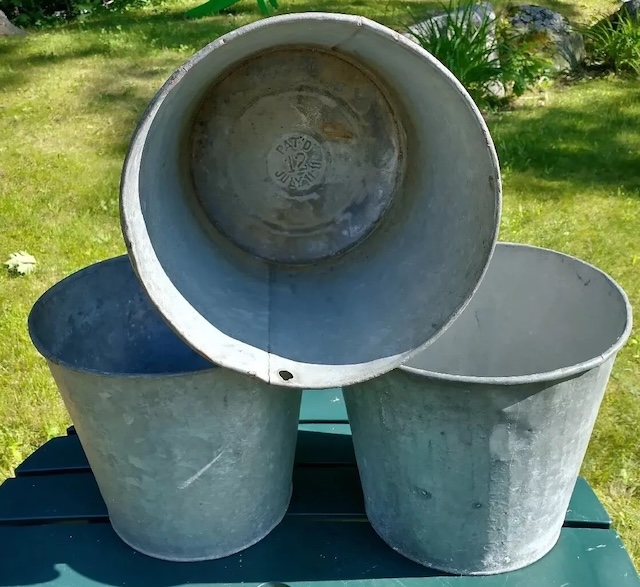 A set of vintage washtubs stacked together, showcasing their versatility and the timeless appeal of galvanized steel