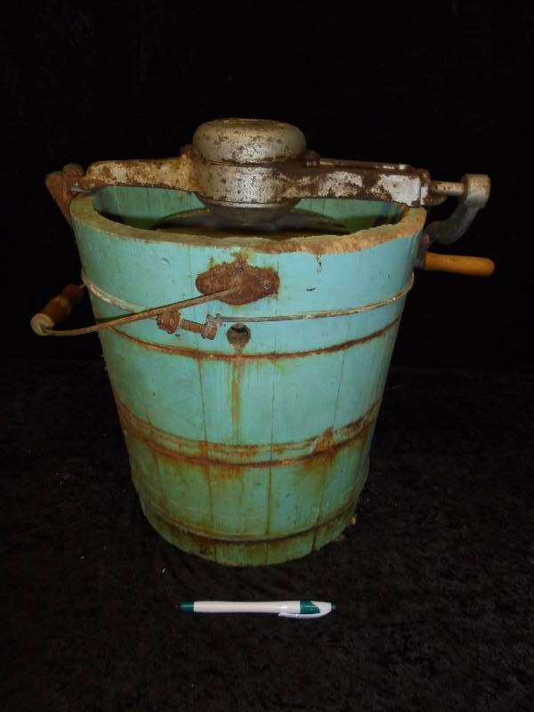 A side profile of the Vintage Mary Proctor Ice Cream Maker, featuring its weathered blue wooden bucket and timeless craftsmanship