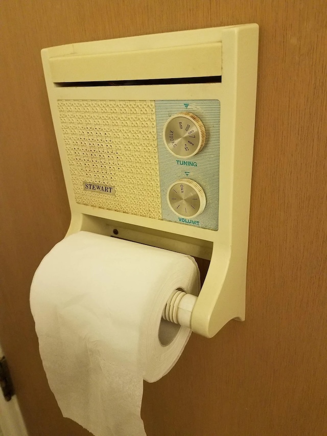 A Stewart-brand vintage restroom radio featuring a classic off-white design, providing both music and functionality in one handy unit