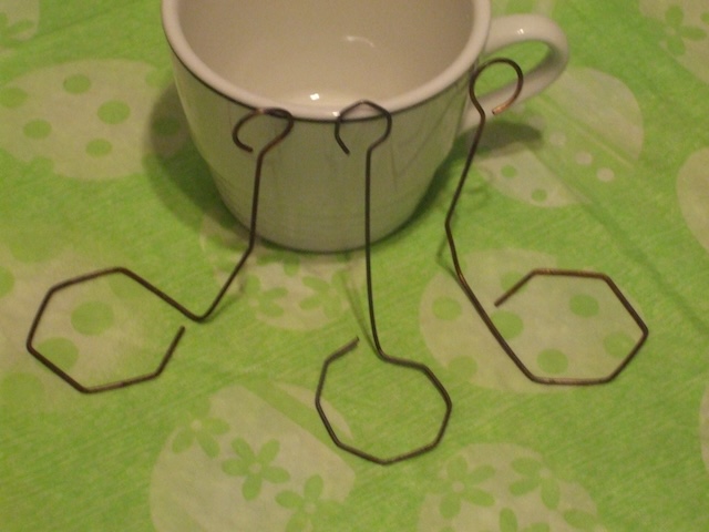 Multiple egg dippers displayed next to a cup, a testament to their essential role in the Easter traditions of the past