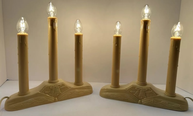 Lit vintage candles with intricate designs, perfect for bringing back the cozy atmosphere of holiday evenings