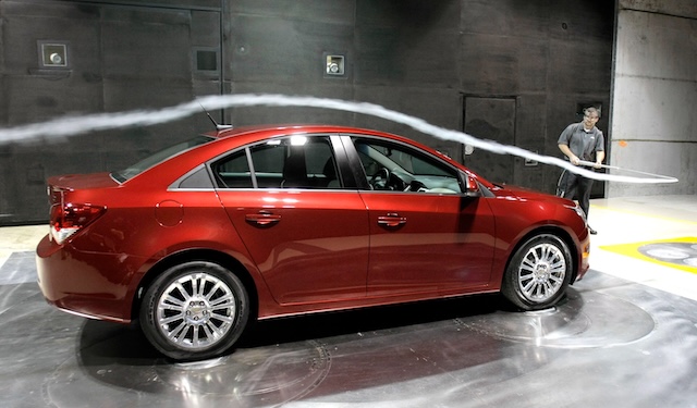 Smoke is blown over a 2011 Chevy Cruze in a wind tunnel to test its aerodynamics