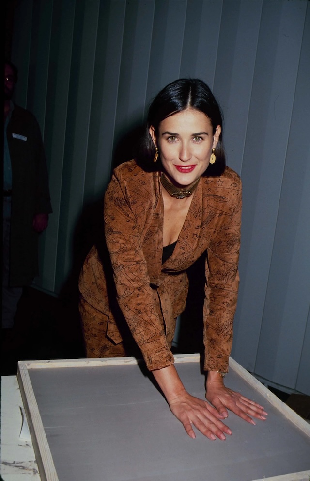 The actor sported a sleek copper suit and choker while making handprints at Planet Hollywood in 1995