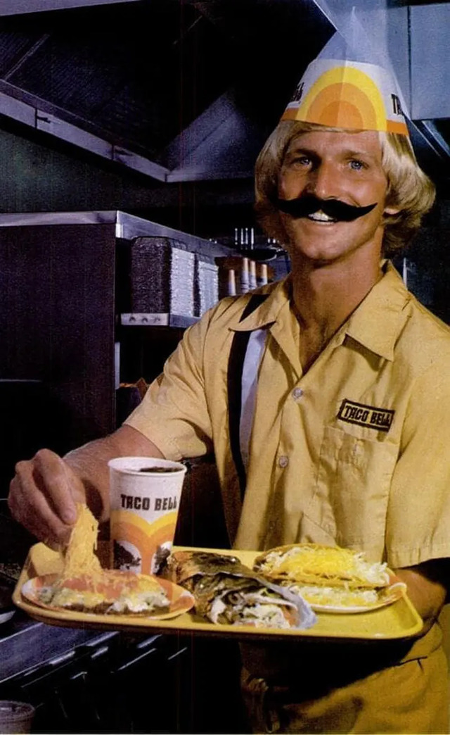 A quirky 1960s image showcasing Taco Bell employees wearing fake mustaches, adding a touch of humor and charm to the vintage vibe, paired with a memorable Bell boy look.