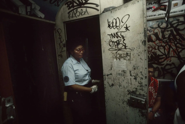 A subway conductor exits his cabin, marking the transition between the mechanical world and the human interactions taking place below ground.