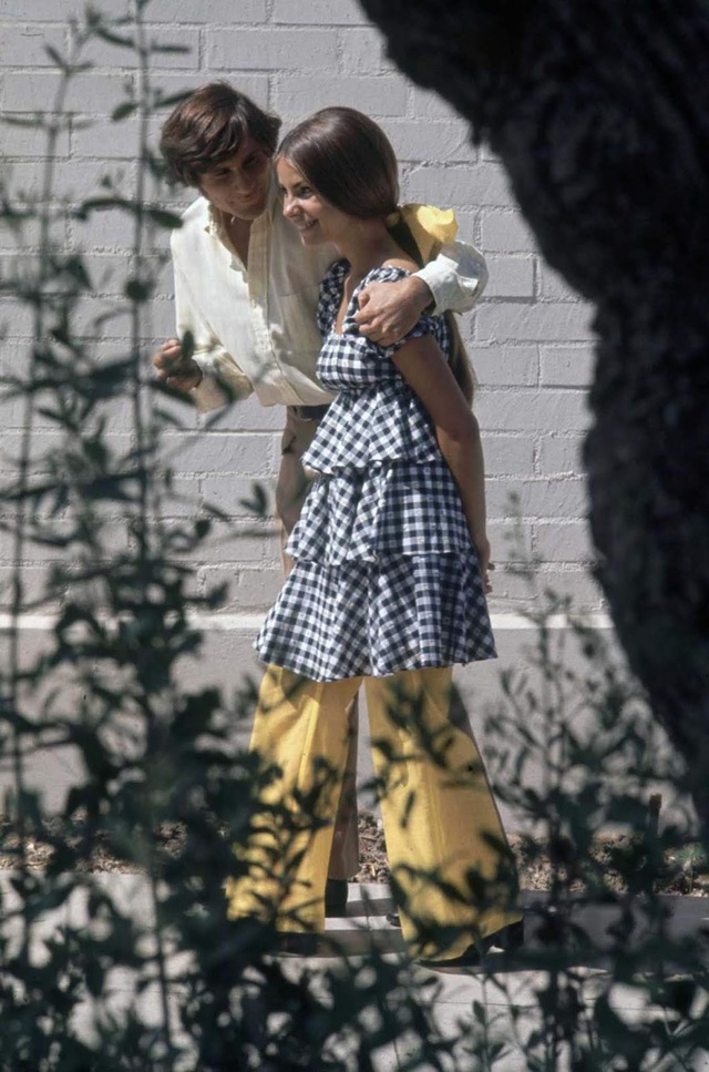 Beverly Hills High School student Erica Farber shared a moment with an unidentified friend, both embracing the vibrant fashion that defined their generation.