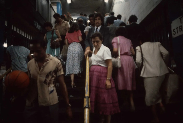 During rush hour, commuters swiftly move up and down stairwells, navigating the city’s subterranean arteries in 1981.