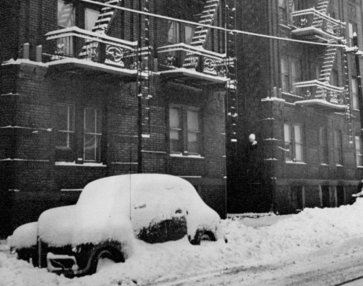 A car buried beneath layers of snow, 1947.