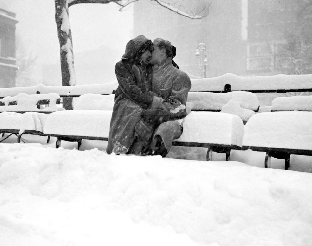 A couple steals a warm kiss on a snow-covered park bench outside New York City’s Municipal Building, 1947.