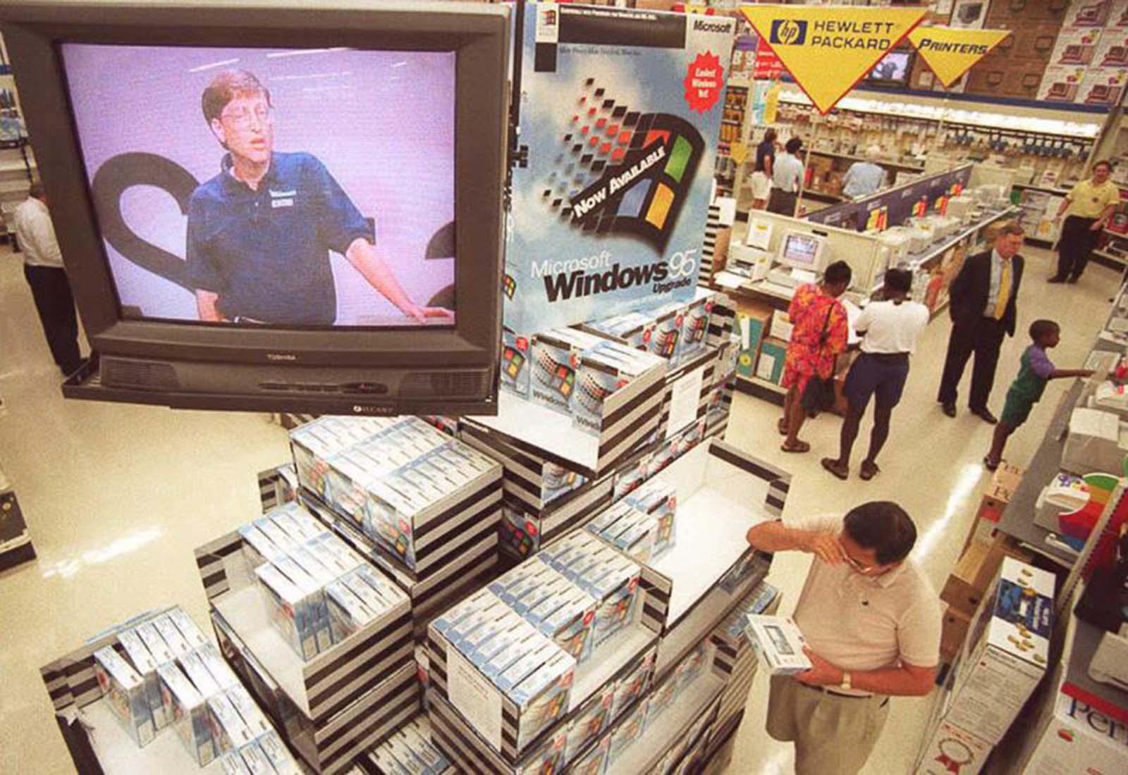 As Bill Gates speaks on television, a Windows 95 display takes center stage at a store in Vienna, Virginia.