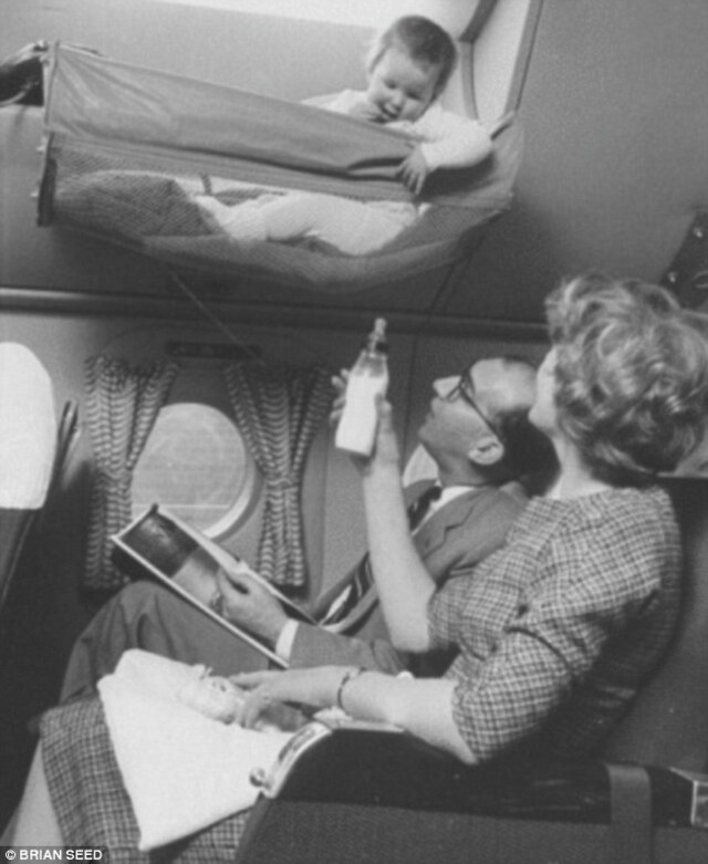 Flying might have looked glamorous, but veteran travelers recall the deafening roar of aircraft in the 1950s. Here, parents soothe their little one with a bottle of milk amidst the noise.