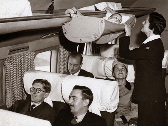 In the 1950s, parents flying with infants placed their babies in bassinets suspended above passengers' heads. This 1953 photo captures elegantly dressed families aboard a British Overseas Airways Corporation (BOAC) aircraft—now known as British Airways.