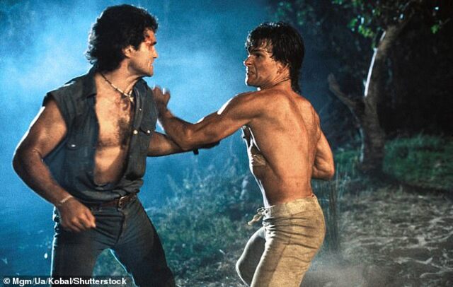 Patrick Swayze’s fight scenes in Road House were no Hollywood illusion—every hit was real. In fact, during one intense battle, he accidentally fractured his co-star’s eye socket, as revealed in a recent candid interview. (Pictured with Marshall Teague).