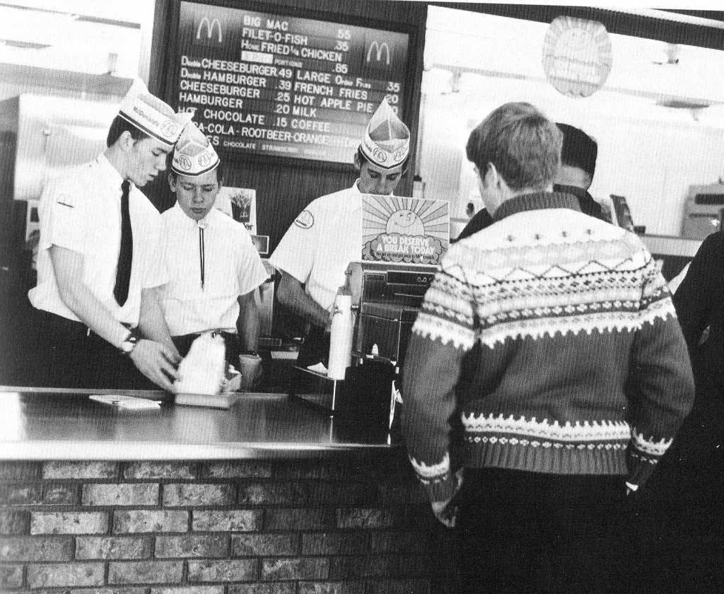 The McDonald's crew in 1969, working hard behind the counter in their classic uniforms.