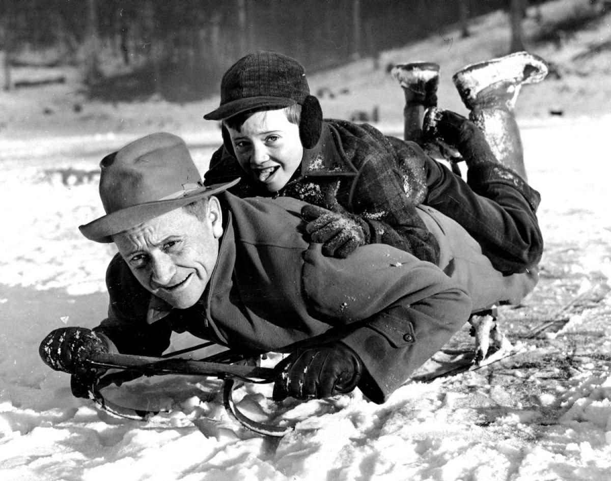 U.S. Supreme Court Justice William Douglas enjoys a classic winter pastime, sledding with his son, 1942.