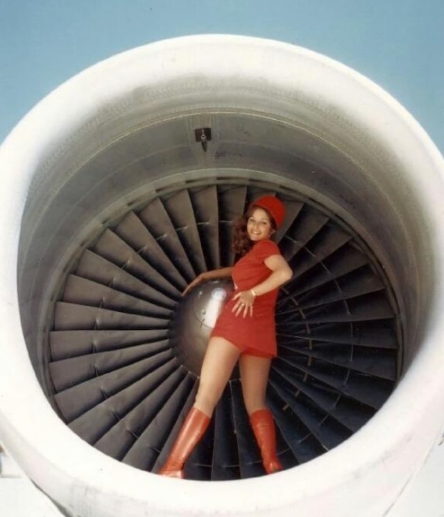 A Pacific Southwest Airlines flight attendant playfully mimics a Canada Goose (circa 1970s