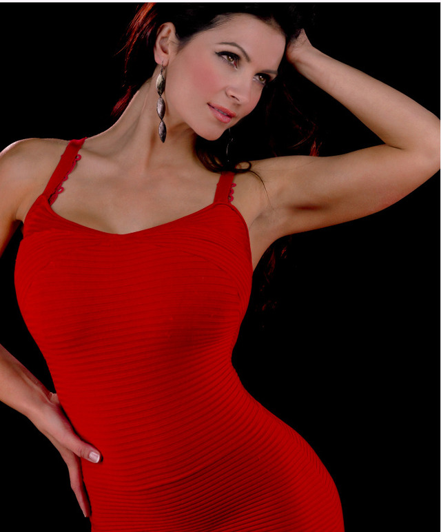 Denise Milani stuns in a bold red dress, effortlessly combining classic glamour with modern sophistication—an icon of confidence and timeless beauty.