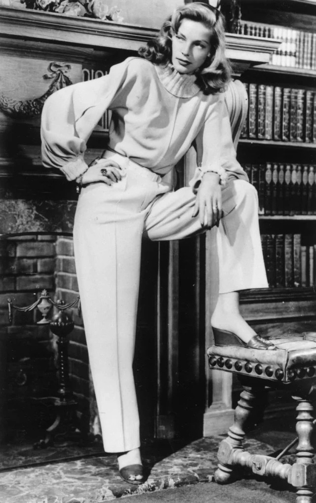 Lauren Bacall exuding elegance and confidence in a classic studio portrait, a timeless image of Hollywood sophistication.