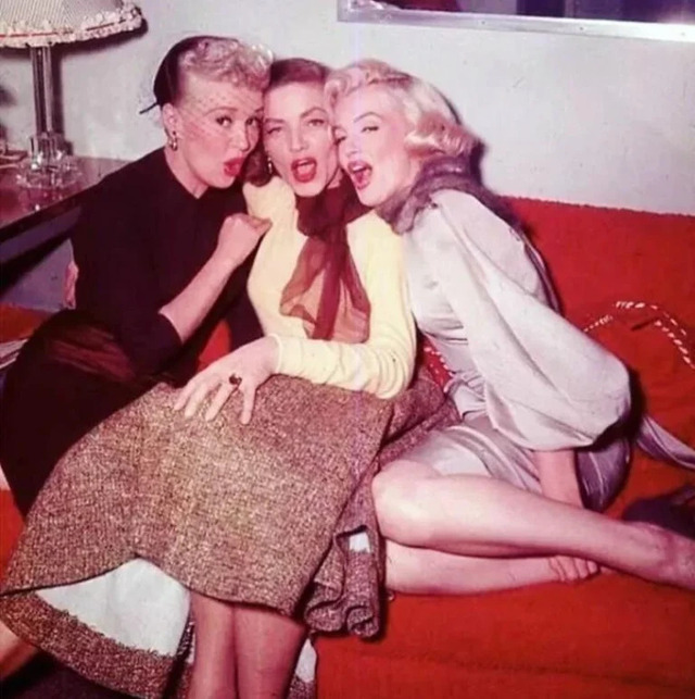 Lauren Bacall sharing a joyful moment with Marilyn Monroe and Betty Grable — Hollywood’s legendary leading ladies united in timeless glamour.