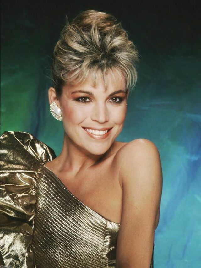 A glamorous portrait of Vanna in a golden metallic dress, reflecting her Hollywood sparkle in the show’s early years.