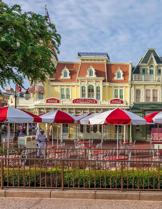 Daytime view of Casey’s Corner with its signature red-and-white umbrellas and outdoor seating.