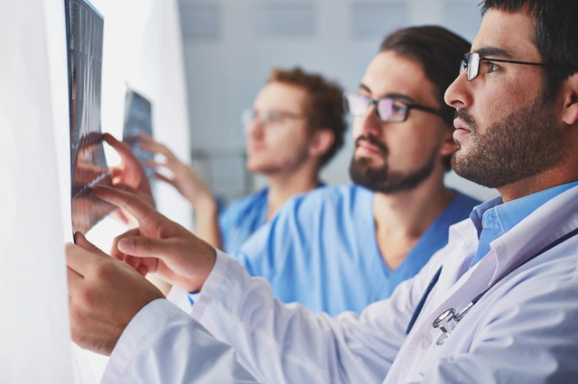 Doctors carefully reviewing scans—early detection dramatically improves survival rates.