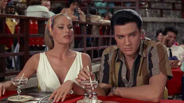Ursula Andress in a timeless moment with Elvis Presley from Fun in Acapulco, where their on-screen chemistry sparks unforgettable nostalgia.