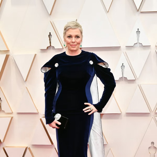 Olivia Colman graced the ceremony in a stunning long-sleeved blue gown paired with a dramatic cape—both made entirely from sustainable materials.